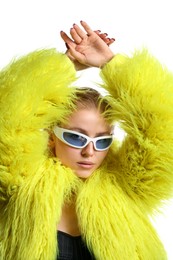 Photo of Beautiful woman in stylish sunglasses and fur coat posing on white background