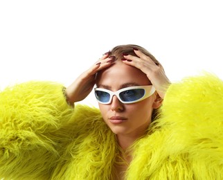 Photo of Beautiful woman in stylish sunglasses and fur coat posing on white background
