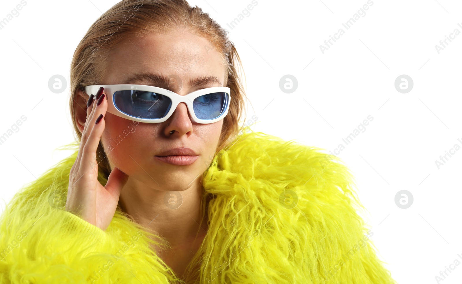 Photo of Beautiful woman in stylish sunglasses and fur coat posing on white background