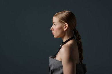 Photo of Beautiful woman on dark grey background. Space for text