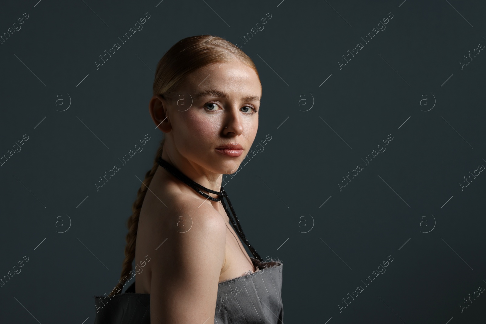 Photo of Fashionable portrait of beautiful woman on dark grey background