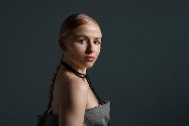 Photo of Fashionable portrait of beautiful woman on dark grey background