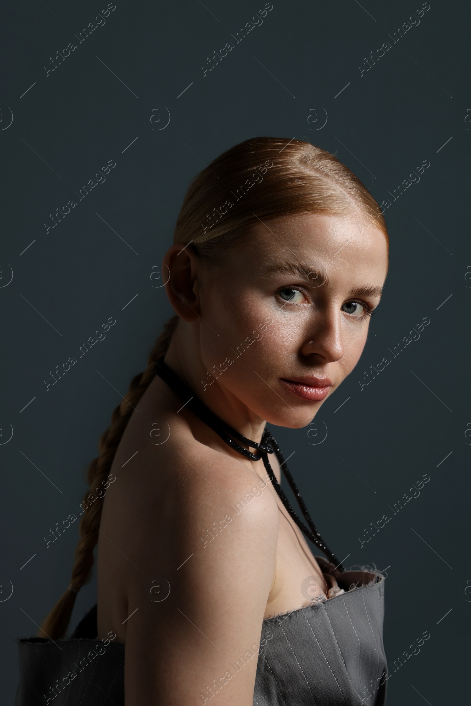 Photo of Fashionable portrait of beautiful woman on dark grey background