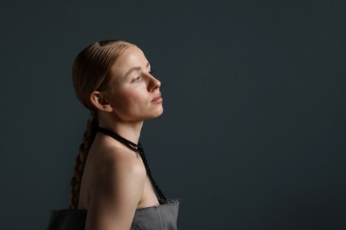 Photo of Beautiful woman on dark grey background. Space for text