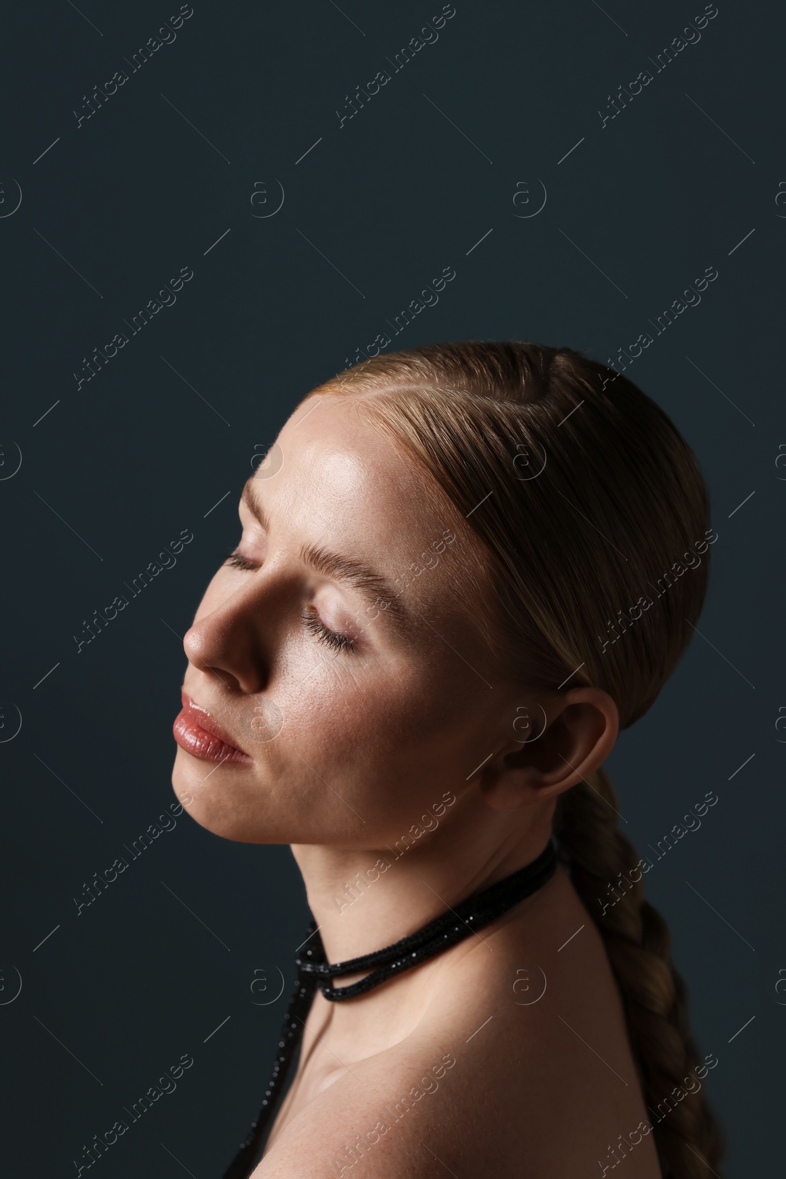 Photo of Beautiful woman on dark grey background, closeup