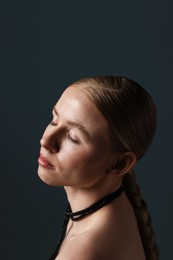 Photo of Beautiful woman on dark grey background, closeup