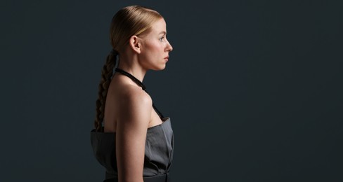 Photo of Beautiful woman on dark grey background. Space for text