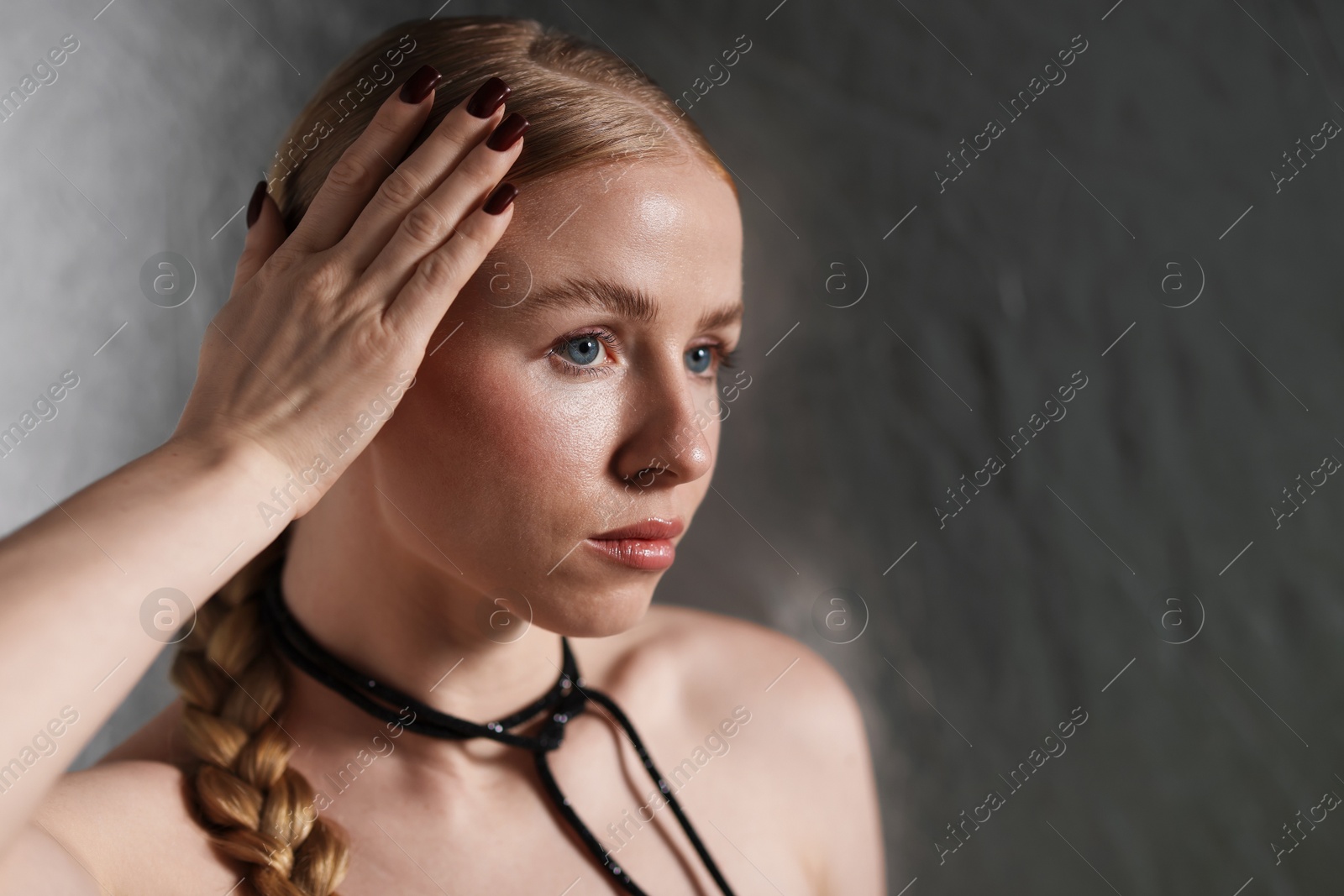 Photo of Beautiful woman on metallic background. Space for text