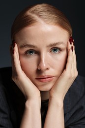 Photo of Portrait of beautiful woman on dark background, closeup