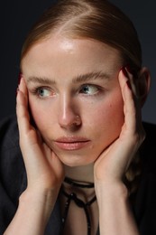 Photo of Beautiful woman posing on dark background, closeup