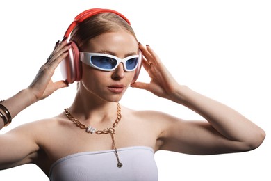 Photo of Beautiful woman in stylish sunglasses, bijouterie and headphones listening to music on white background