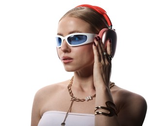 Photo of Beautiful woman in stylish sunglasses, bijouterie and headphones listening to music on white background