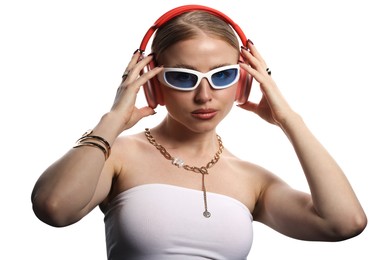 Photo of Fashionable portrait of beautiful woman in stylish sunglasses, bijouterie and headphones listening to music on white background
