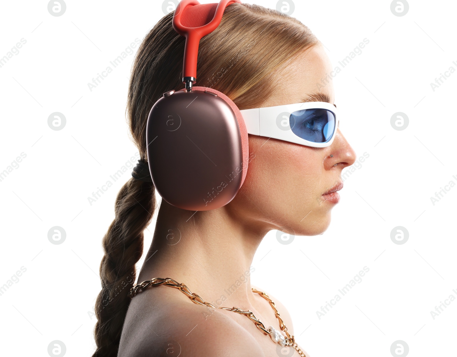 Photo of Beautiful woman in stylish sunglasses, necklace and headphones listening to music on white background
