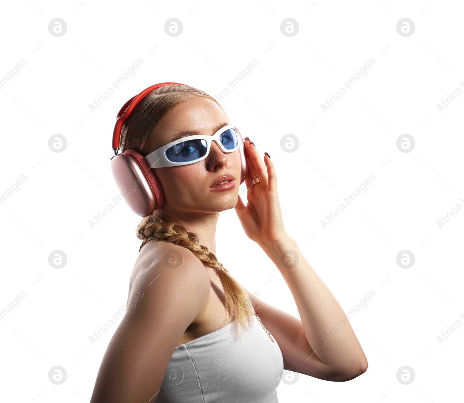 Photo of Fashionable portrait of beautiful woman in stylish sunglasses, bijouterie and headphones listening to music on white background