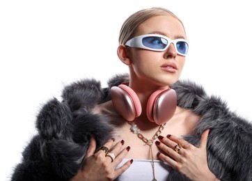 Photo of Beautiful woman in stylish sunglasses, bijouterie, fur coat and headphones on white background