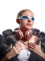 Photo of Beautiful woman in stylish sunglasses, bijouterie, fur coat and headphones on white background