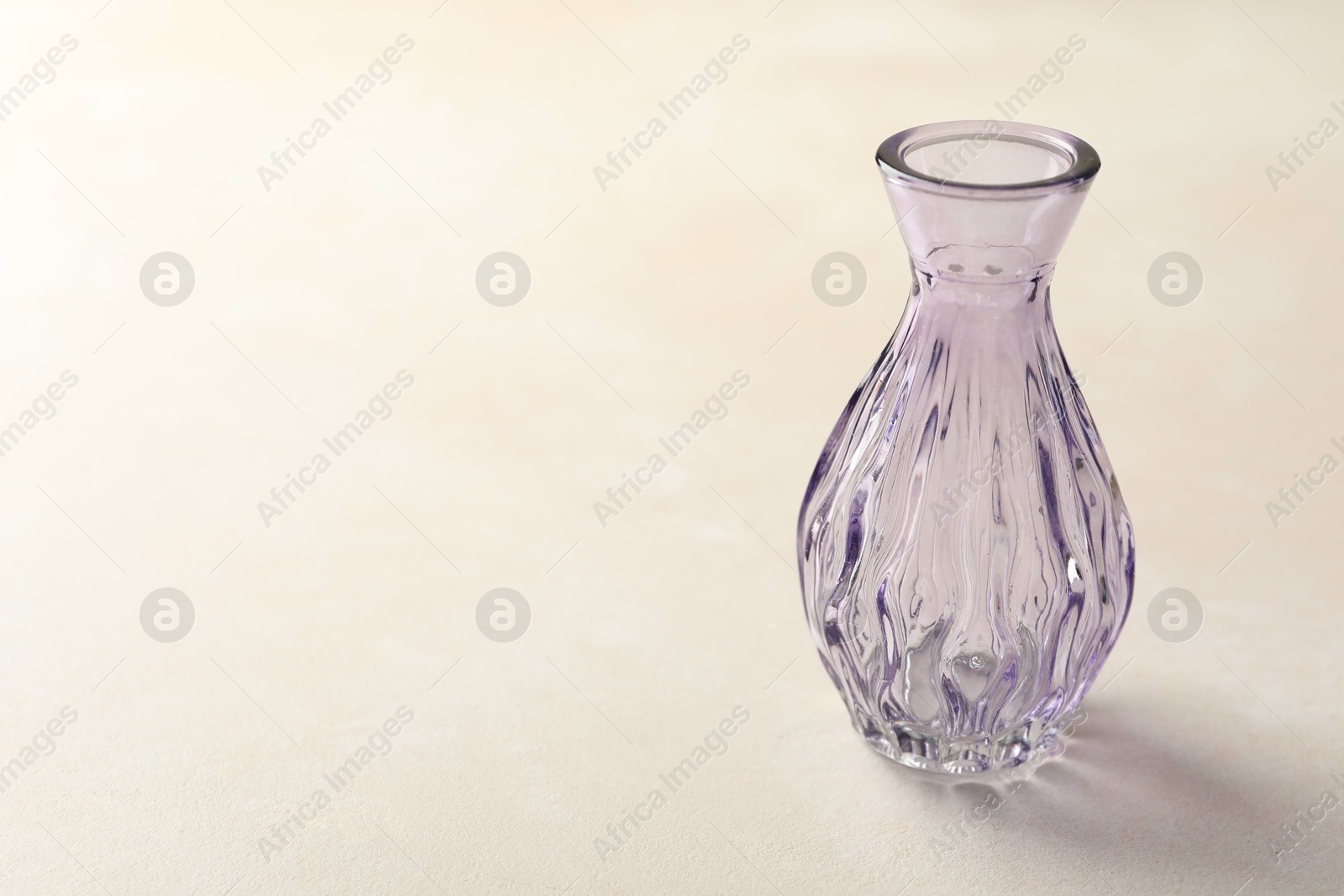 Photo of Beautiful glass vase on white table, closeup. Space for text