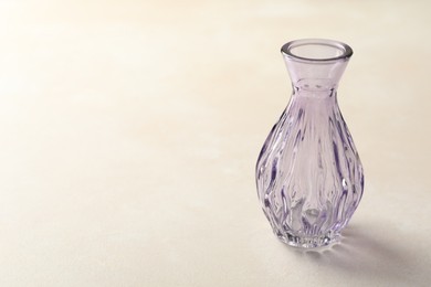 Photo of Beautiful glass vase on white table, closeup. Space for text