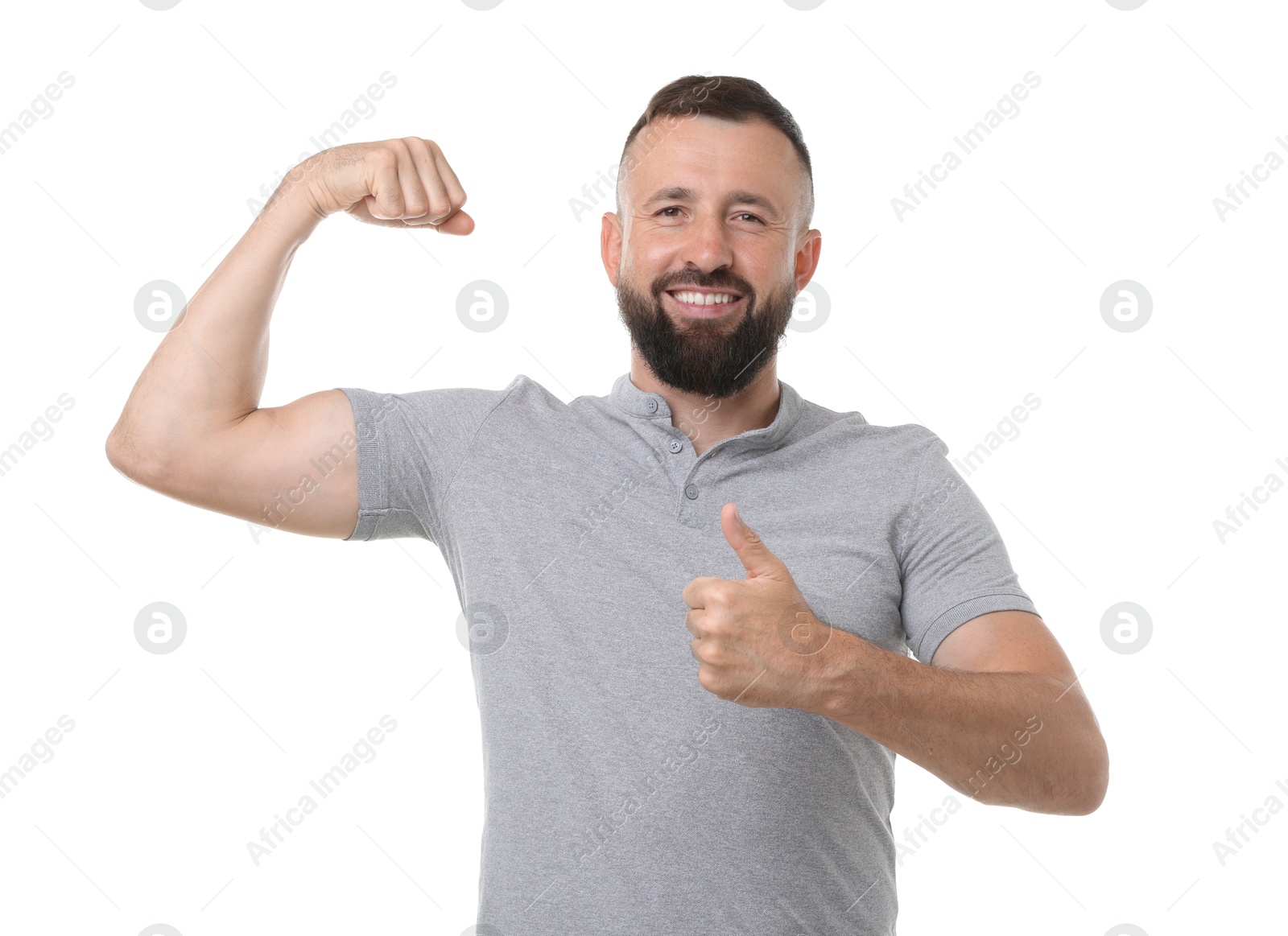 Photo of Strength. Smiling man showing his biceps and thumbs up on white background