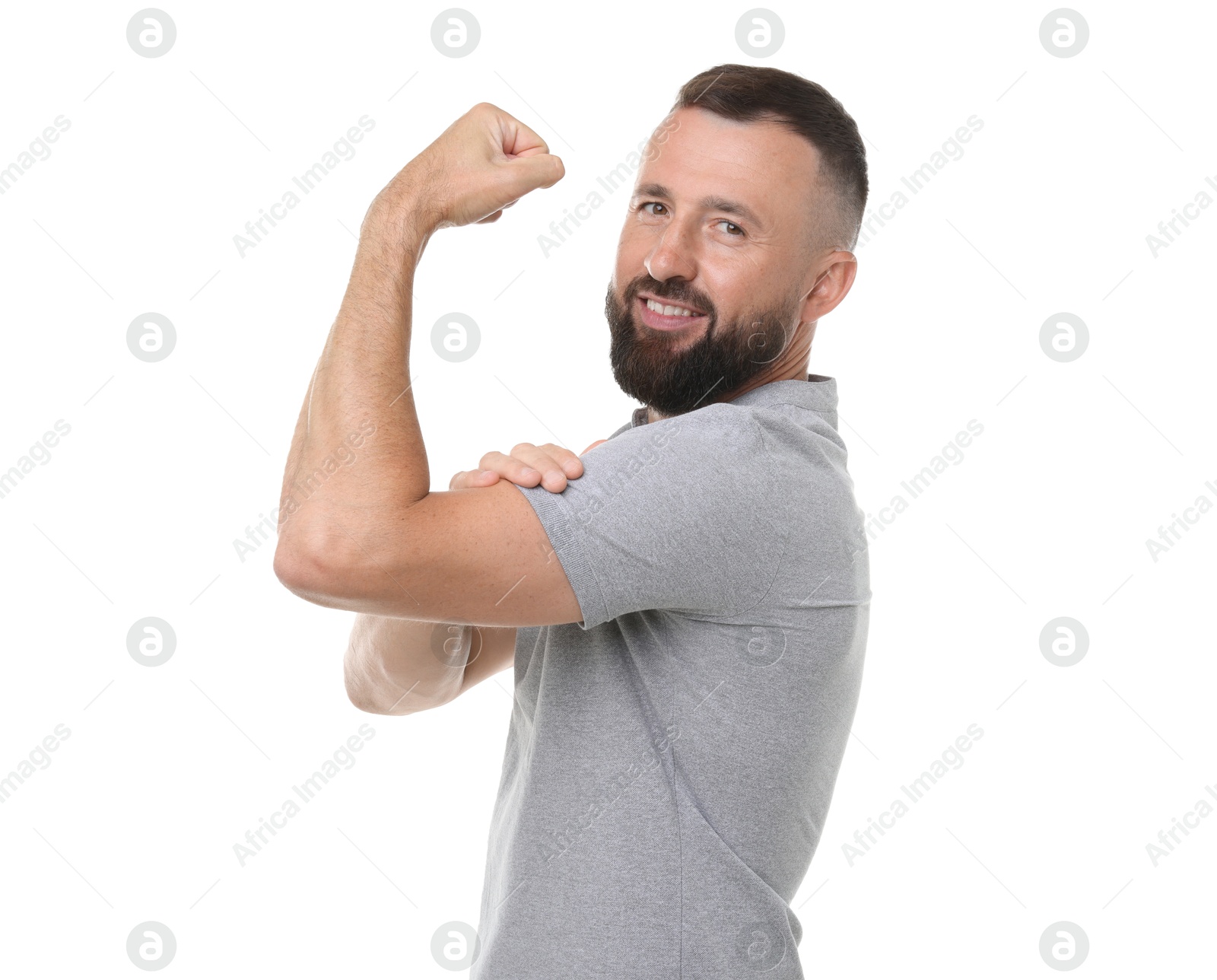 Photo of Strength. Smiling man showing his biceps on white background