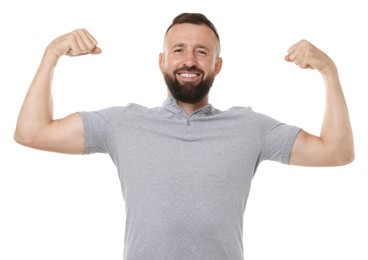 Photo of Strength. Smiling man showing his biceps on white background
