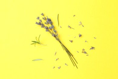 Photo of Fragrant lavender flowers and leaves on yellow background, flat lay