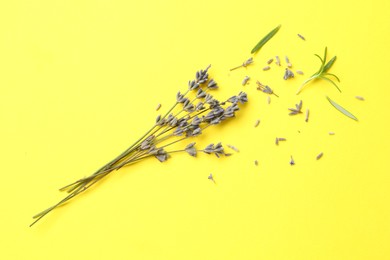 Photo of Fragrant lavender flowers and leaves on yellow background, flat lay