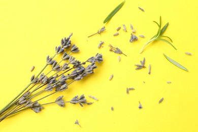 Photo of Fragrant lavender flowers and leaves on yellow background, flat lay
