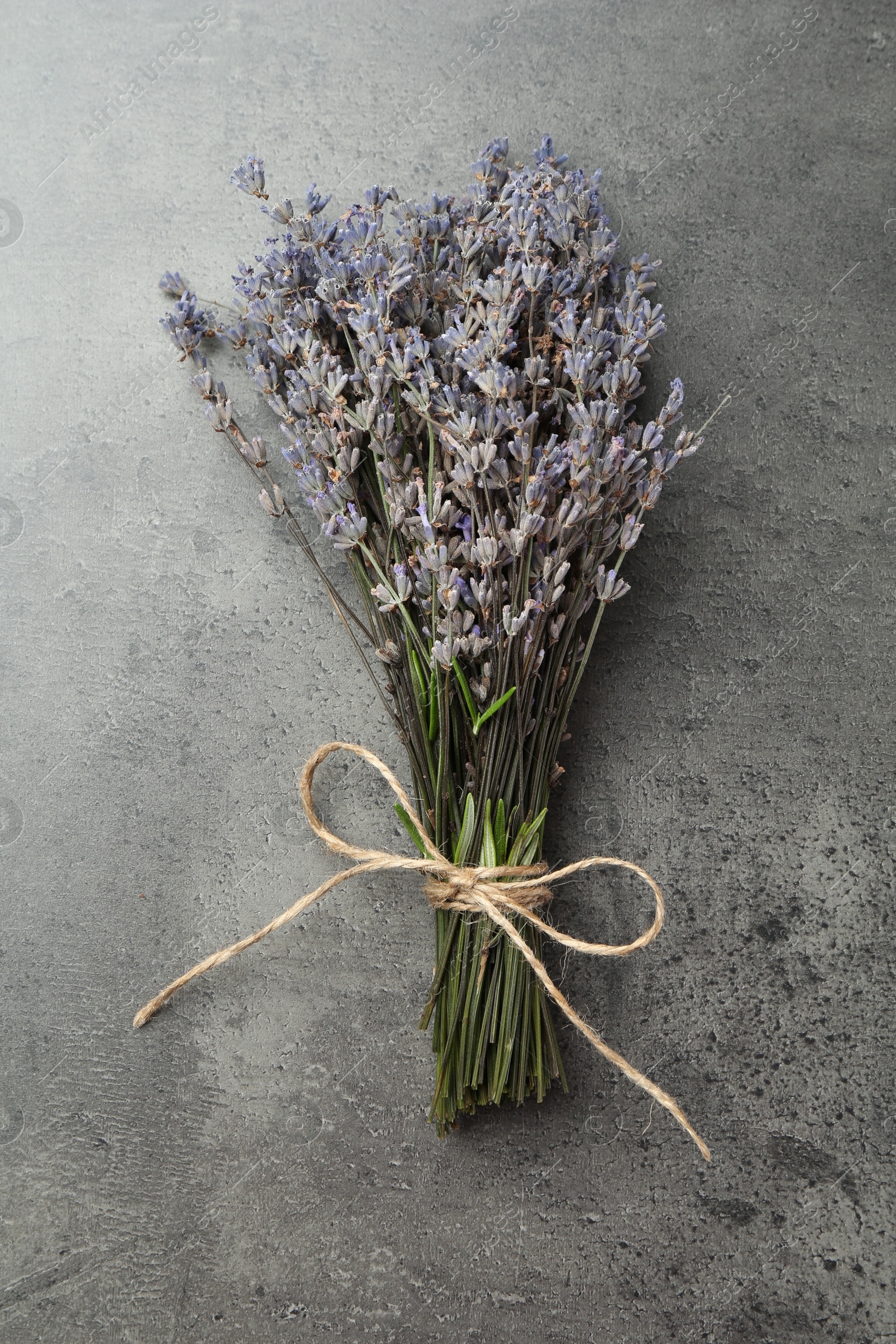 Photo of Bunch of fragrant lavender flowers on grey table, top view