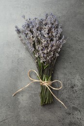 Photo of Bunch of fragrant lavender flowers on grey table, top view