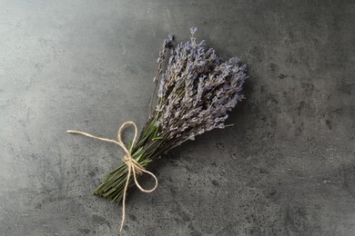 Photo of Bunch of fragrant lavender flowers on grey table, top view