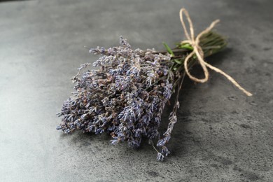 Photo of Bunch of fragrant lavender flowers on grey table, closeup
