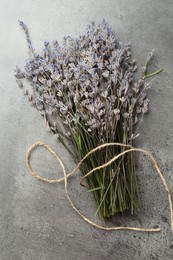 Photo of Bunch of fragrant lavender flowers on grey table, top view