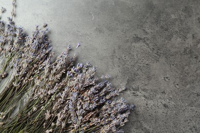 Photo of Fragrant lavender flowers on grey table, flat lay. Space for text