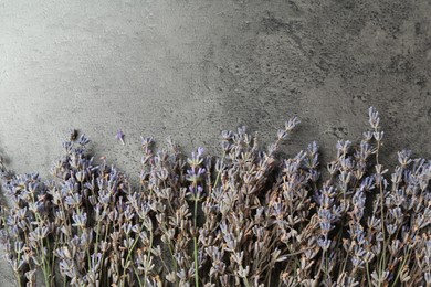 Photo of Fragrant lavender flowers on grey table, flat lay. Space for text