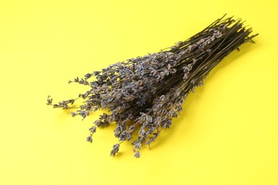 Photo of Bunch of fragrant lavender flowers on yellow background