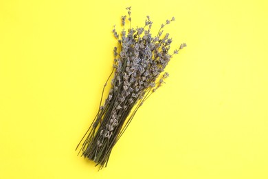 Photo of Bunch of fragrant lavender flowers on yellow background, top view