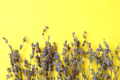 Photo of Fragrant lavender flowers on yellow background, flat lay