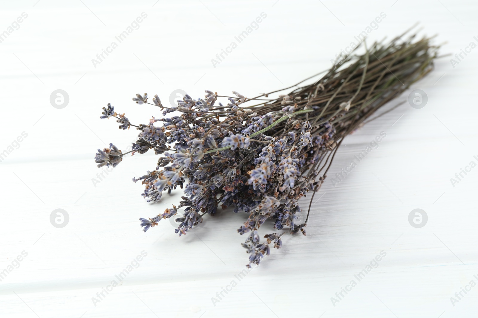 Bunch of fragrant lavender flowers on white wooden table, closeup Photo of Bunch of fragrant lavender flowers on white wooden table, closeup