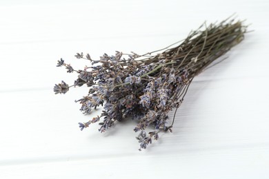 Photo of Bunch of fragrant lavender flowers on white wooden table, closeup