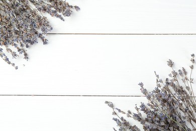 Photo of Fragrant lavender flowers on white wooden table, flat lay. Space for text