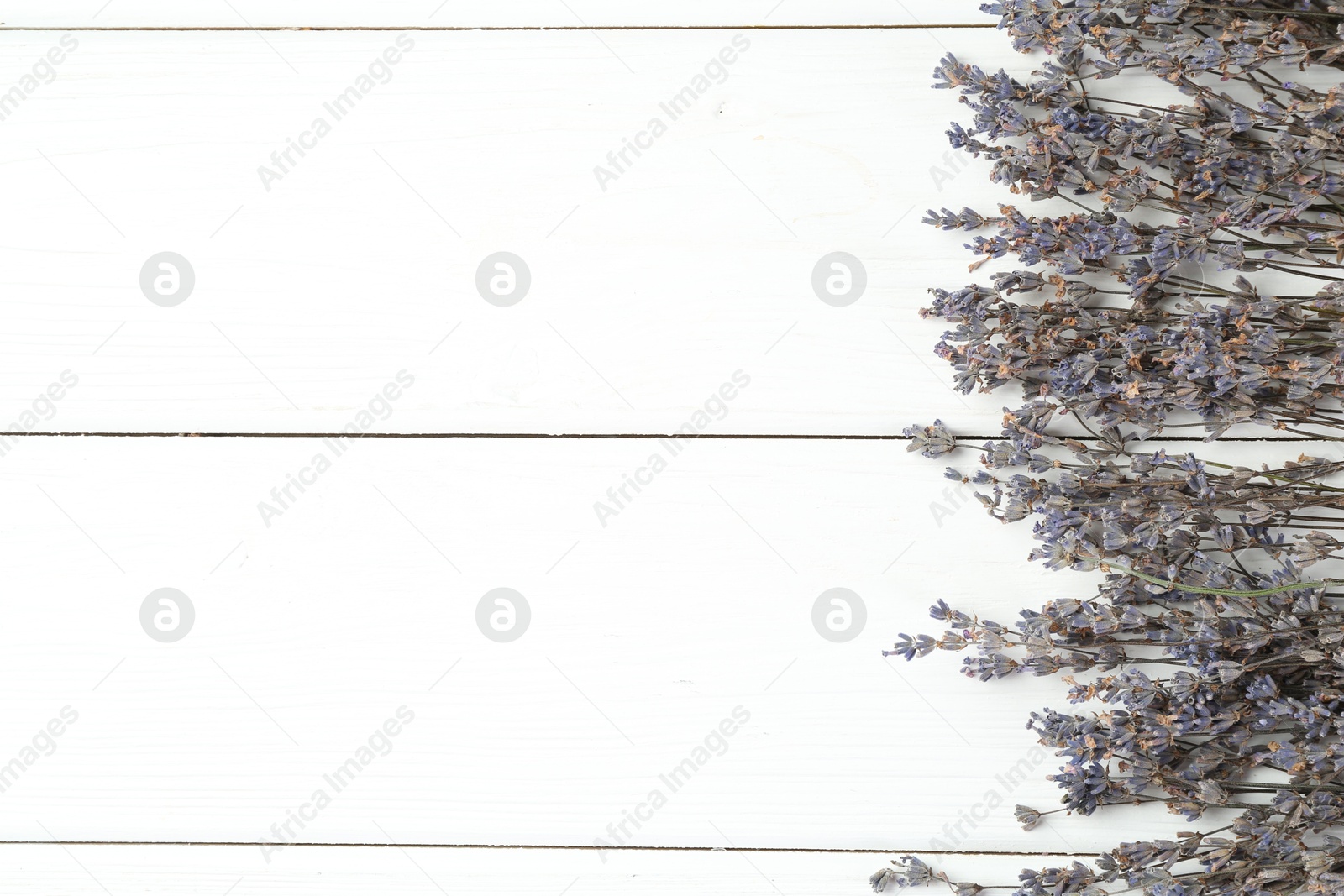 Photo of Fragrant lavender flowers on white wooden table, flat lay. Space for text