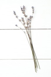 Photo of Fragrant lavender flowers on white wooden table, flat lay