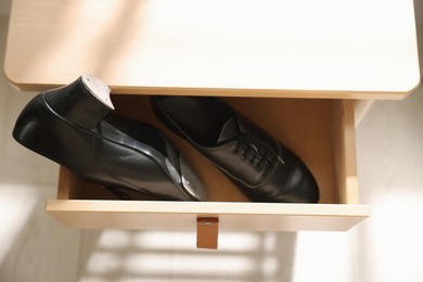 Photo of Pair of shoes for tap dance in drawer indoors, above view