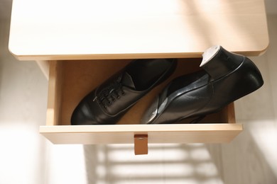 Photo of Pair of shoes for tap dance in drawer indoors, above view