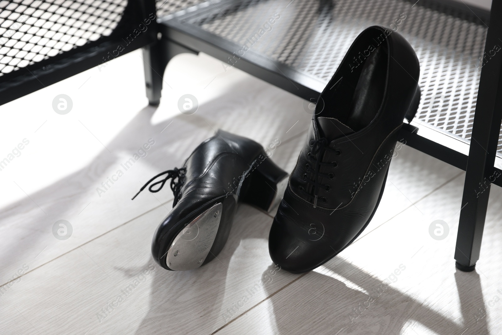 Photo of Pair of shoes for tap dance near shoe storage indoors