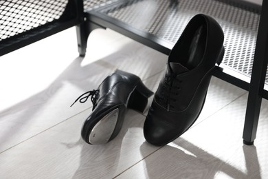 Photo of Pair of shoes for tap dance near shoe storage indoors