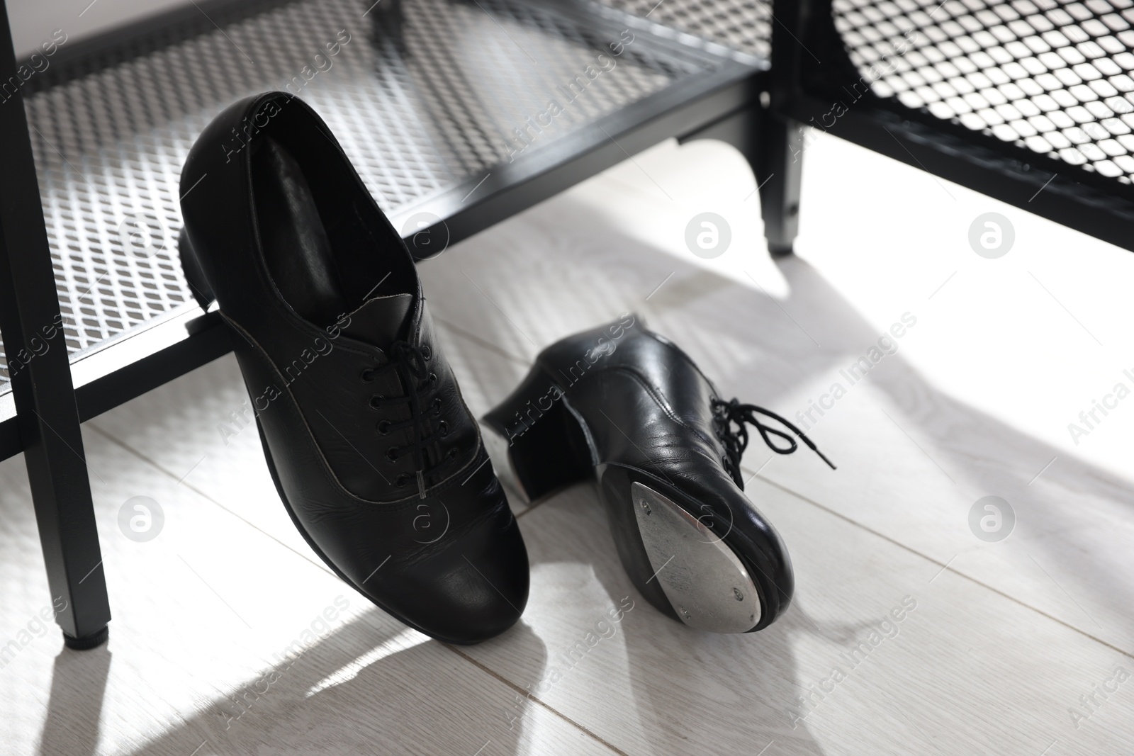 Photo of Pair of shoes for tap dance near shoe storage indoors