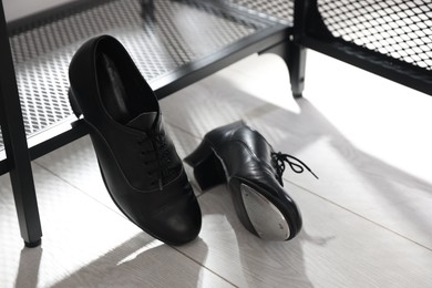 Photo of Pair of shoes for tap dance near shoe storage indoors
